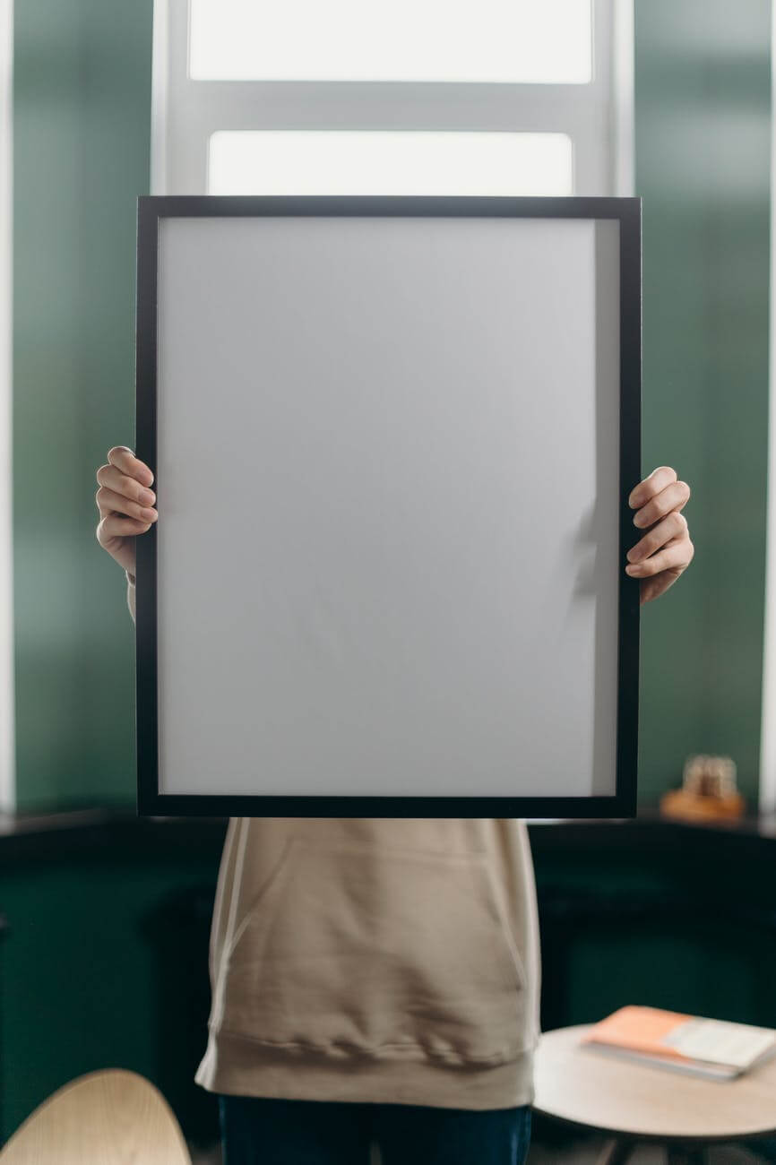 person holding white and black frame
